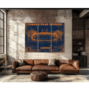 Auburn Tigers Jordan Hare Stadium Print as a 3 panel canvas wrap above a leather sofa