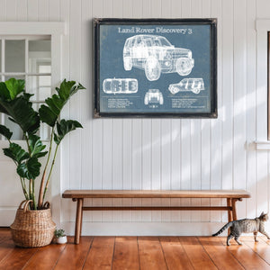 Land Rover Discovery Blueprint Art Print framed in Vintage Black above a rustic console table