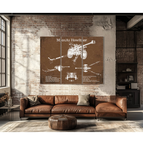 M101A1 Howitzer Art Print as a 3 panel canvas wrap above a leather sofa