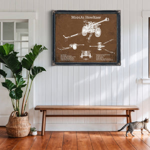 M101A1 Howitzer Art Print framed in Vintage Black above a rustic console table