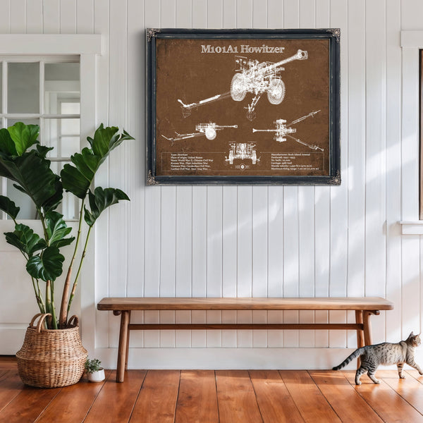 M101A1 Howitzer Art Print framed in Vintage Black above a rustic console table